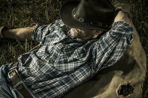 Cowboy man laying down photo