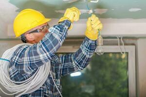 Caucasian Electrician at Work photo