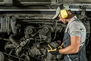 Shuttle Bus Diesel Engine Maintenance Performed by Technician photo