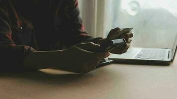 Women holding credit card and using smartphones at home.Online shopping, internet banking, store online, payment, spending money, e-commerce payment at the store, credit card, concept video