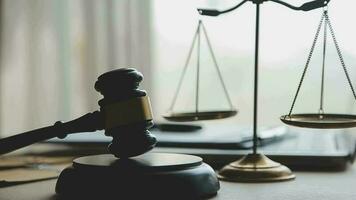 Justice and law concept.Male judge in a courtroom with the gavel, working with, computer and docking keyboard, eyeglasses, on table in morning light video