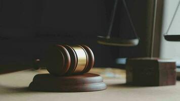 Justice and law concept.Male judge in a courtroom with the gavel, working with, computer and docking keyboard, eyeglasses, on table in morning light video