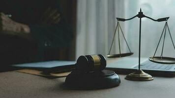 Justice and law concept.Male judge in a courtroom with the gavel, working with, computer and docking keyboard, eyeglasses, on table in morning light video