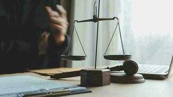 Justice and law concept.Male judge in a courtroom with the gavel, working with, computer and docking keyboard, eyeglasses, on table in morning light video