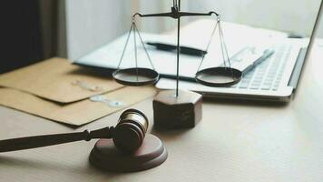 Justice and law concept.Male judge in a courtroom with the gavel, working with, computer and docking keyboard, eyeglasses, on table in morning light video