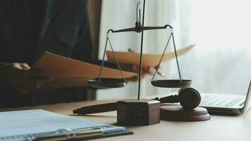 Justice and law concept.Male judge in a courtroom with the gavel, working with, computer and docking keyboard, eyeglasses, on table in morning light video