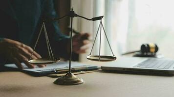 Justice and law concept.Male judge in a courtroom with the gavel, working with, computer and docking keyboard, eyeglasses, on table in morning light video