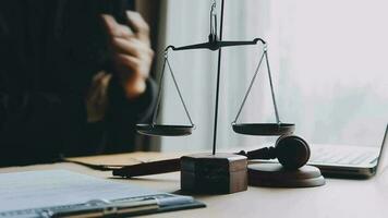 Justice and law concept.Male judge in a courtroom with the gavel, working with, computer and docking keyboard, eyeglasses, on table in morning light video
