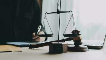 Justice and law concept.Male judge in a courtroom with the gavel, working with, computer and docking keyboard, eyeglasses, on table in morning light video