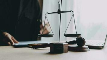 Justice and law concept.Male judge in a courtroom with the gavel, working with, computer and docking keyboard, eyeglasses, on table in morning light video