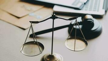 Justice and law concept.Male judge in a courtroom with the gavel, working with, computer and docking keyboard, eyeglasses, on table in morning light video