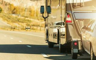 RV Motor Coach with Pull Vehicle on a Highway photo