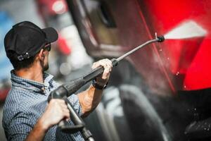 Driver Washing His Semi Truck photo