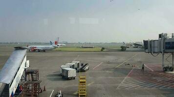 Tangerang, Indonesia in May 2023. Several aircraft, namely Air Asia, Lion Air and several other aircraft on the apron and runway of Terminal 2 of Soekarno Hatta Airport. video