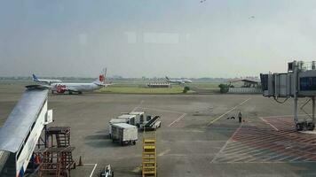 Tangerang, Indonesia in May 2023. Several aircraft, namely Air Asia, Lion Air and several other aircraft on the apron and runway of Terminal 2 of Soekarno Hatta Airport. video