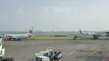 Tangerang, Indonesia in May 2023. Several aircraft, namely Air Asia, Lion Air and several other aircraft on the apron and runway of Terminal 2 of Soekarno Hatta Airport. video