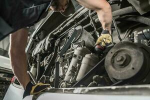 Auto Mechanic Repairing Bus Engine. photo