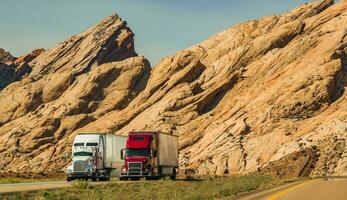 Two Semi Trucks Passing Scenic Utah Landscape photo