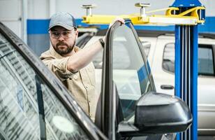 Working Caucasian Auto Service Technician photo