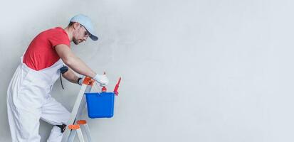 Interior Painter Contractor Worker on a Ladder photo