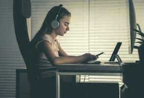Girl in Front of Smartphone Tablet and Desktop Computer photo