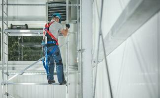 Construction Worker Climbing on Scaffolding Structure photo