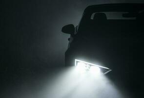 Modern Active Car LED Headlights Performing in Fog photo