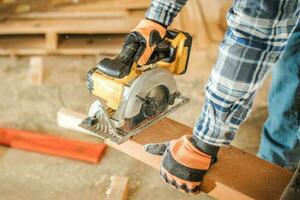 Cut To Size Wood Beam Using Portable Circular Saw photo