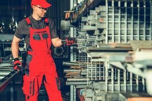 Metalworking Industry Worker Selecting Piece of Square Tube photo