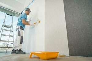 Men Applying Vinyl Wallpaper in a Room photo