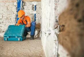 Construction Worker Inside Remodeled Concrete House Interior photo