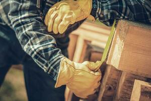 Carpenter Measuring Wood Beams Material photo