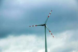 Wind farm or windmill in cloudy weather in Austria in Europe, allows you to get clean energy. It's sustainable, renewable energy for the environment photo