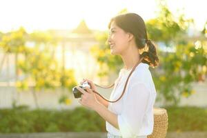 Portrait of asian woman traveler using camera at street of Bangkok, Thailand. Asia summer tourism vacation concept photo