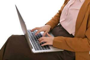 Close up of a business woman using laptop on her lap while sitting photo