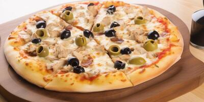 A pizza with tomatoes and olives photo