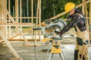 Worker Cutting Wood Elements photo