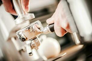 Caucasian Barista Preparing Espresso photo