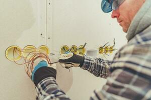 Electric Contractor Straightens Surplus Of Wiring During Installation. photo