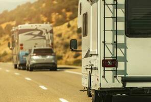 Camper Van and Diesel Pusher Motorhome on a Highway. photo