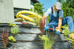 Professional Gardener Installing Drip Line Irrigation System photo