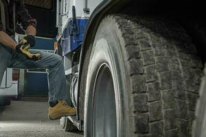 Trucker Preparing His Semi Truck For the Next Heavy Duty Delivery photo