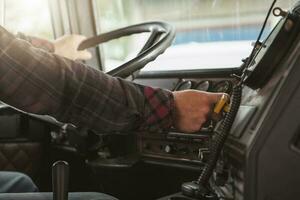 Commercial Semi Truck Driver Inside Of His Vehicle. photo