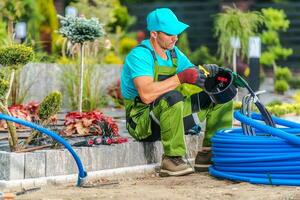 Garden Landscaper Building Backyard Irrigation System photo
