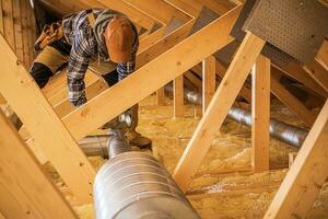 HVAC Worker Installing Air Ducts photo