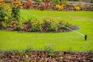 Irrigation System Watering Backyard Landscping Area. photo