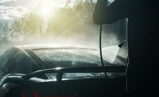 Men Pressure Washing His Performance Exotic Car photo