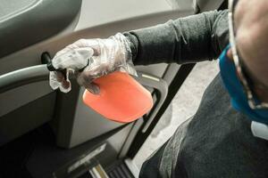 Bus Interior Disinfection by Caucasian Driver photo