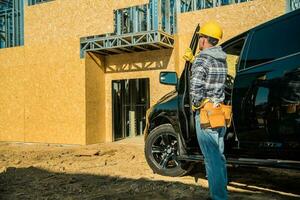 Construction Worker Looking at the Building Under Construction photo