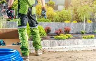 Professional Landscaping Worker with Irrigation System Elements in His Hands photo